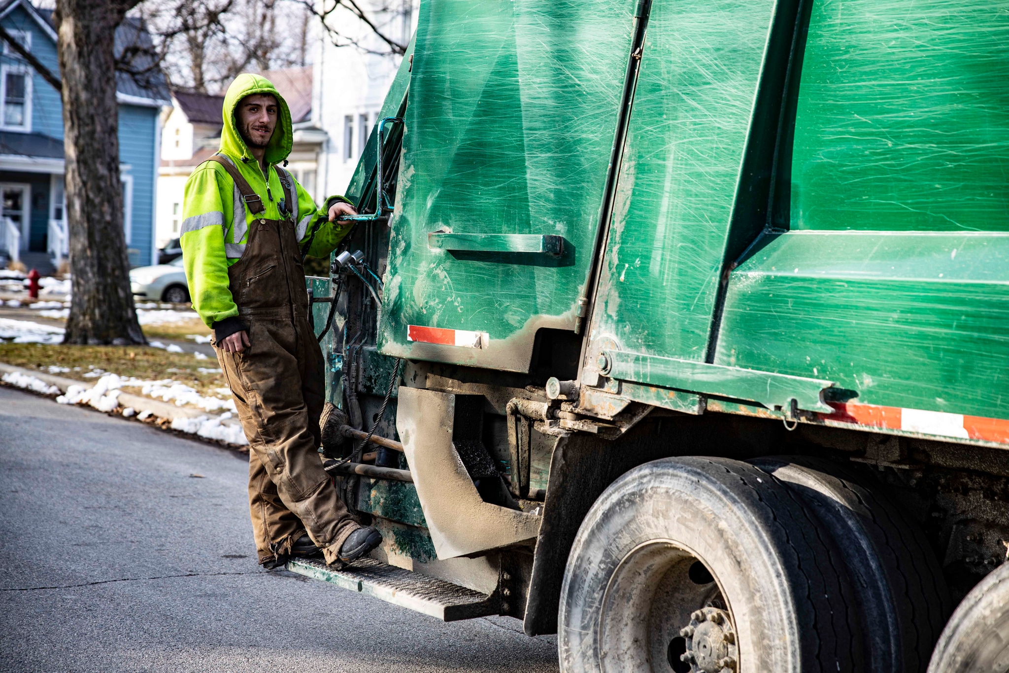 Mike's Trash team member on truck
